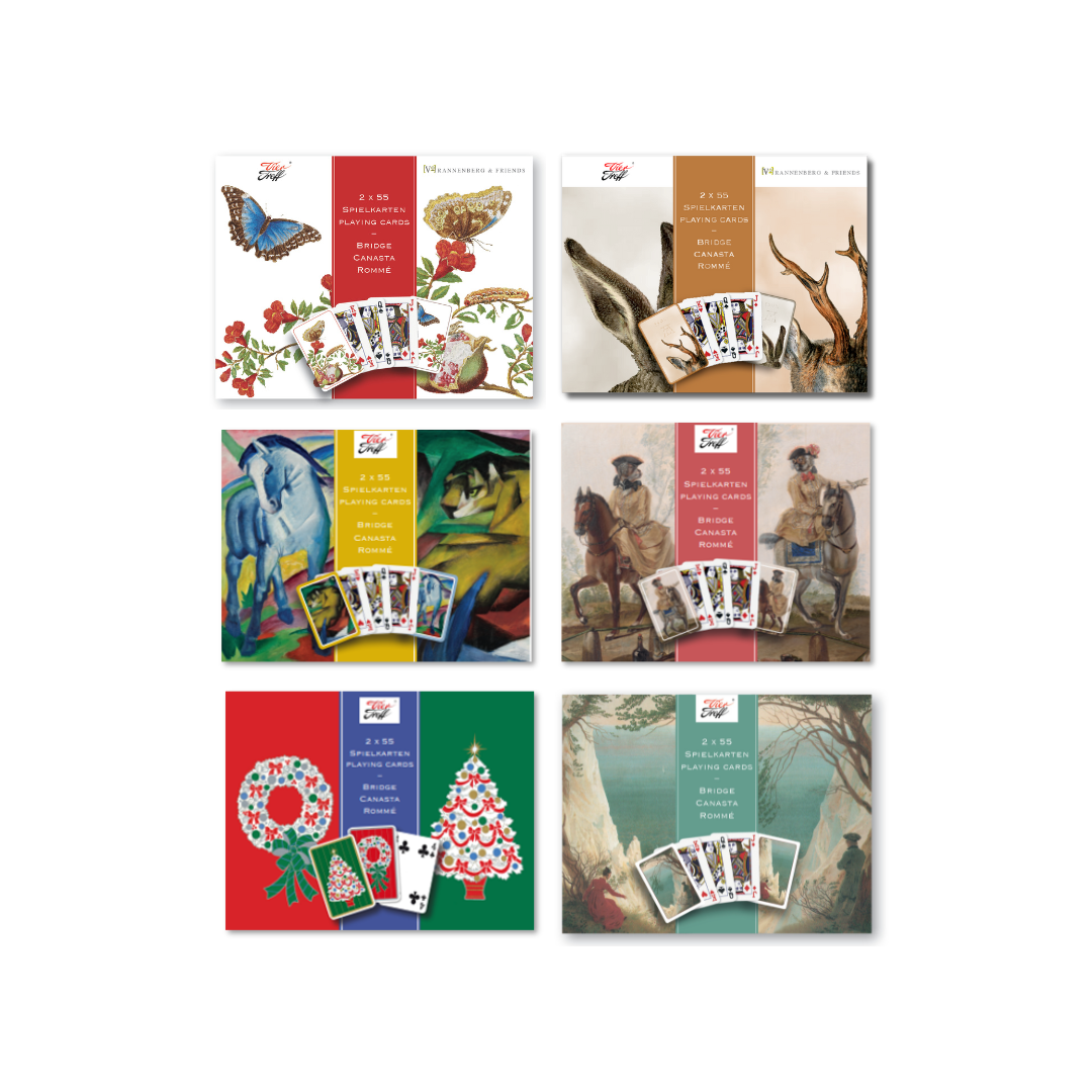 Die Frontseiten der Schachteln der Vier Treff-Spielkarten von Maria Sibylla Merian, Albrecht Dürer, Franz Marc, Christophe Huet, Caspar David Friedrich und den Weihnachts-Spielkarten.